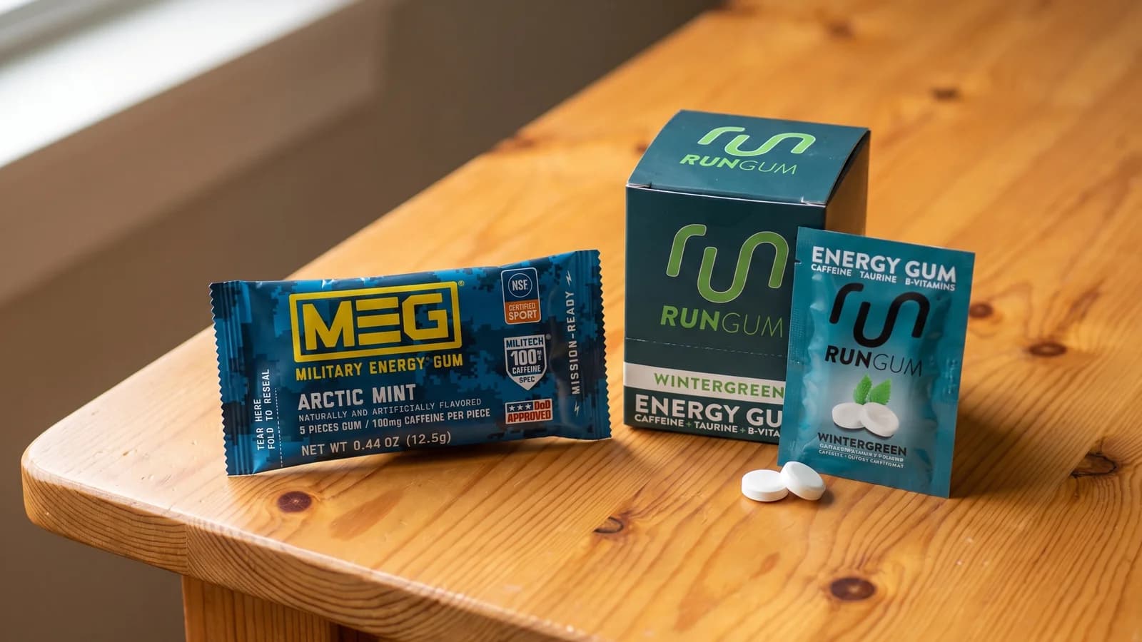 Military Energy Gum packet and Run Gum box and packet on a wooden table